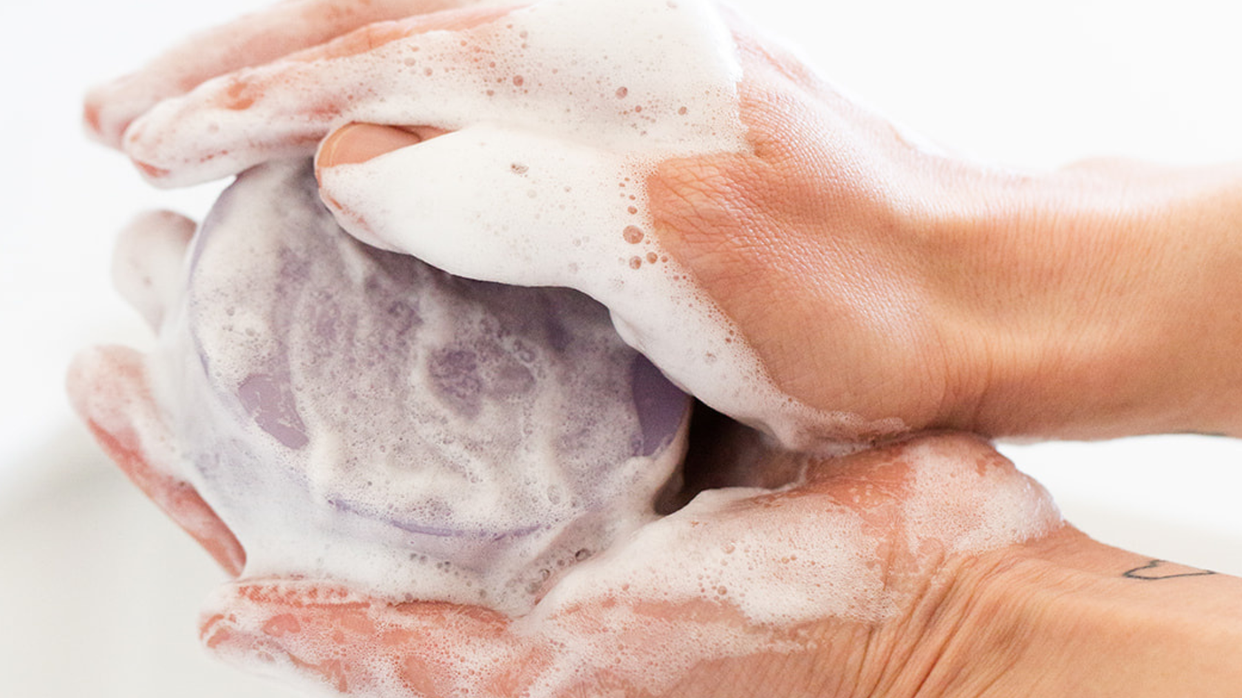 handmade olive oil soap bar with creamy lather on skin
