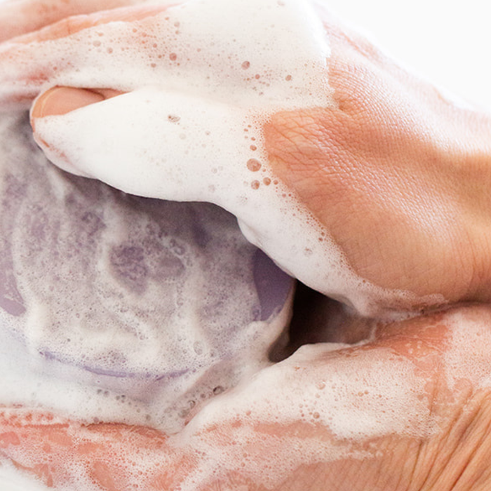 handmade olive oil soap bar with creamy lather on skin