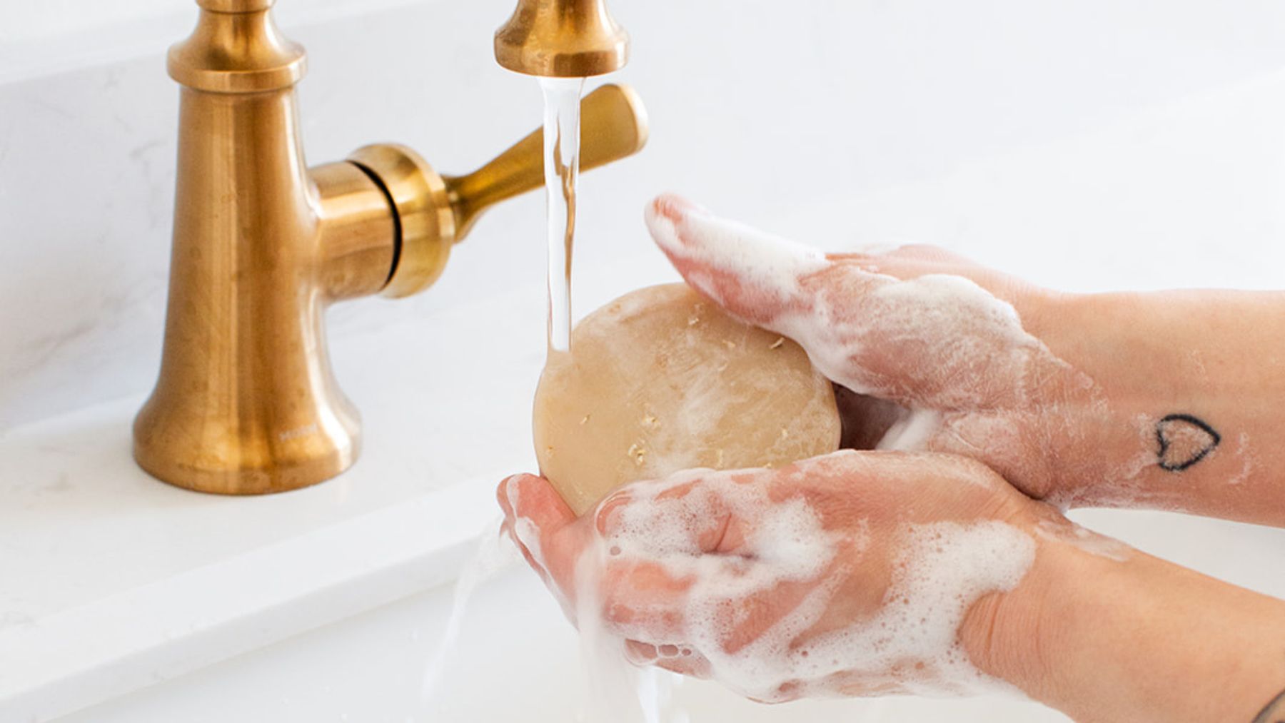 Comparison of plastic body wash bottles versus natural bar soap wrapped in recyclable paper