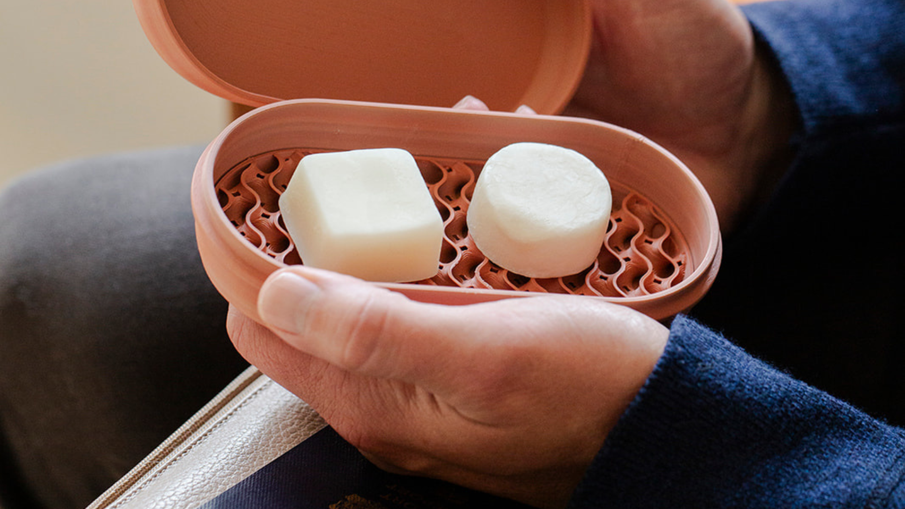 solid shampoo bars packed for travel with toiletry bag and airplane essentials
